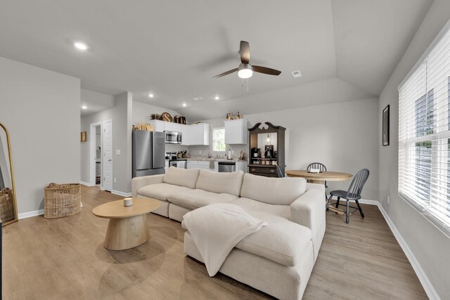  - living room featuring a ceiling fan, recessed lighting, light wood finished floors, baseboards, and vaulted ceiling