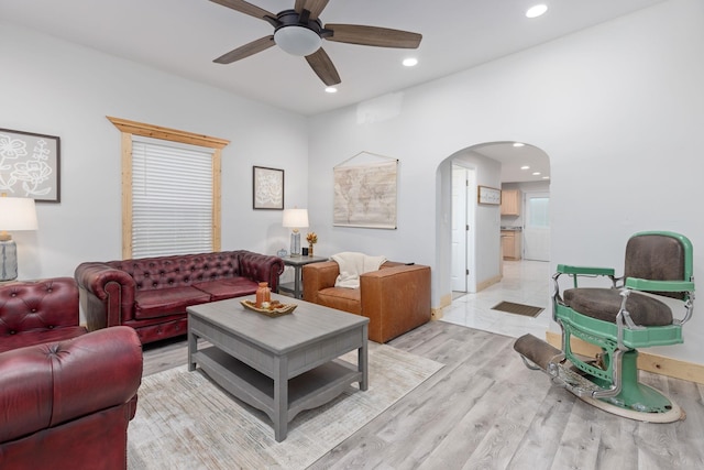 living room with ceiling fan and light hardwood / wood-style floors