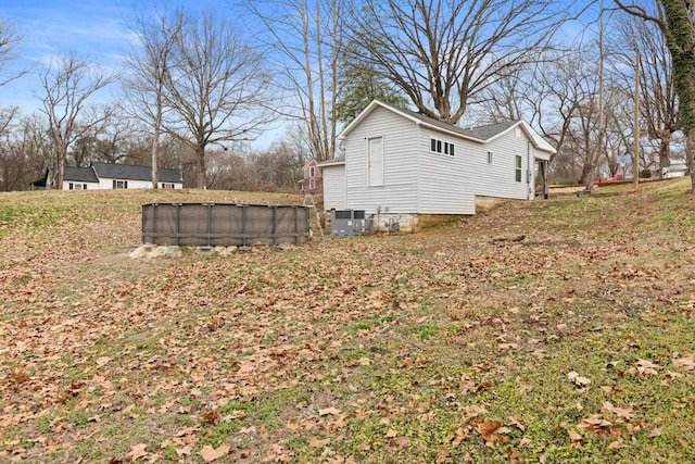 view of side of property featuring central air condition unit