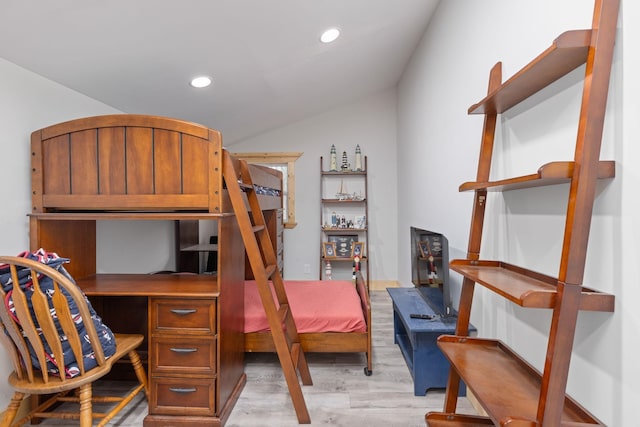 bedroom with vaulted ceiling and light hardwood / wood-style flooring