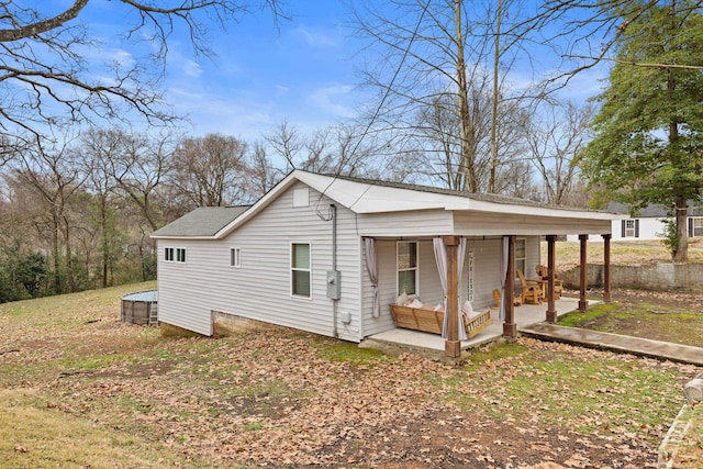 view of side of property with a porch