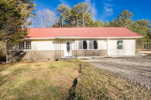 - ranch-style house featuring brick siding, a front lawn, and metal roof