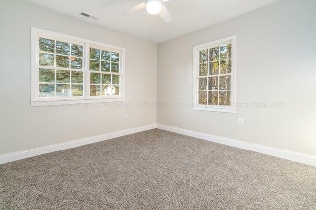  - empty room featuring ceiling fan, baseboards, and carpet flooring