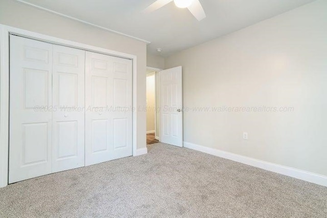  - unfurnished bedroom featuring carpet, a closet, baseboards, and ceiling fan