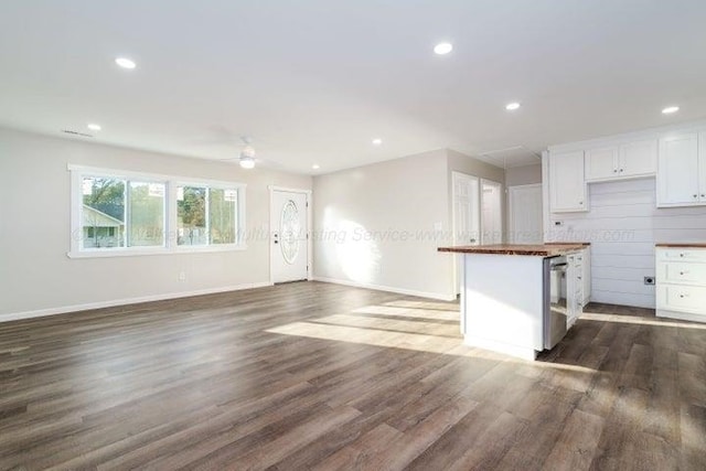  - kitchen with dark wood finished floors, white cabinets, baseboards, dishwasher, and recessed lighting