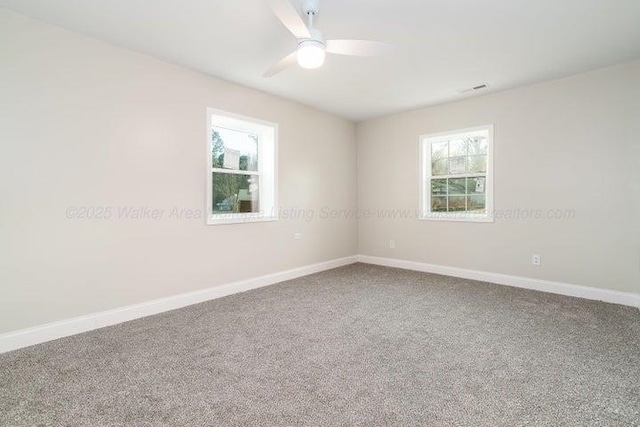 - carpeted empty room with plenty of natural light, baseboards, and ceiling fan