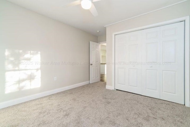  - unfurnished bedroom featuring carpet floors, baseboards, a closet, and ceiling fan