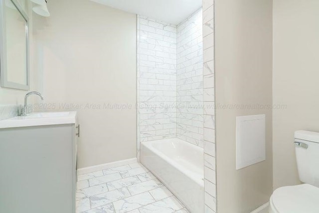  - bathroom with marble look tile flooring, toilet, baseboards, and vanity
