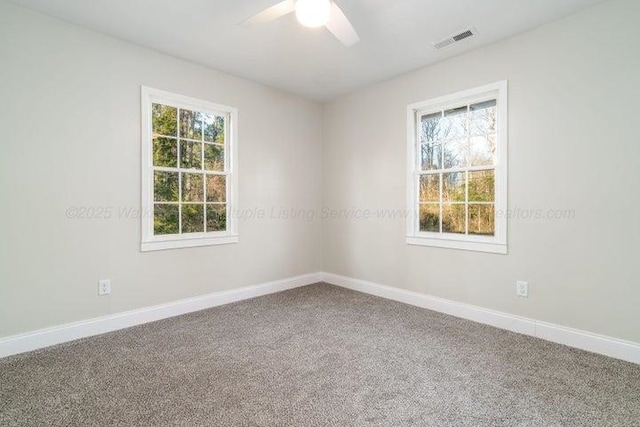  - empty room featuring a ceiling fan, baseboards, and carpet flooring