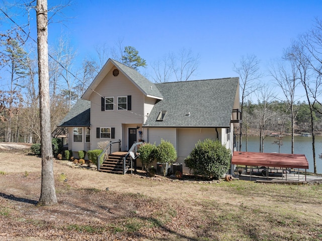 rear view of property featuring roof with shingles