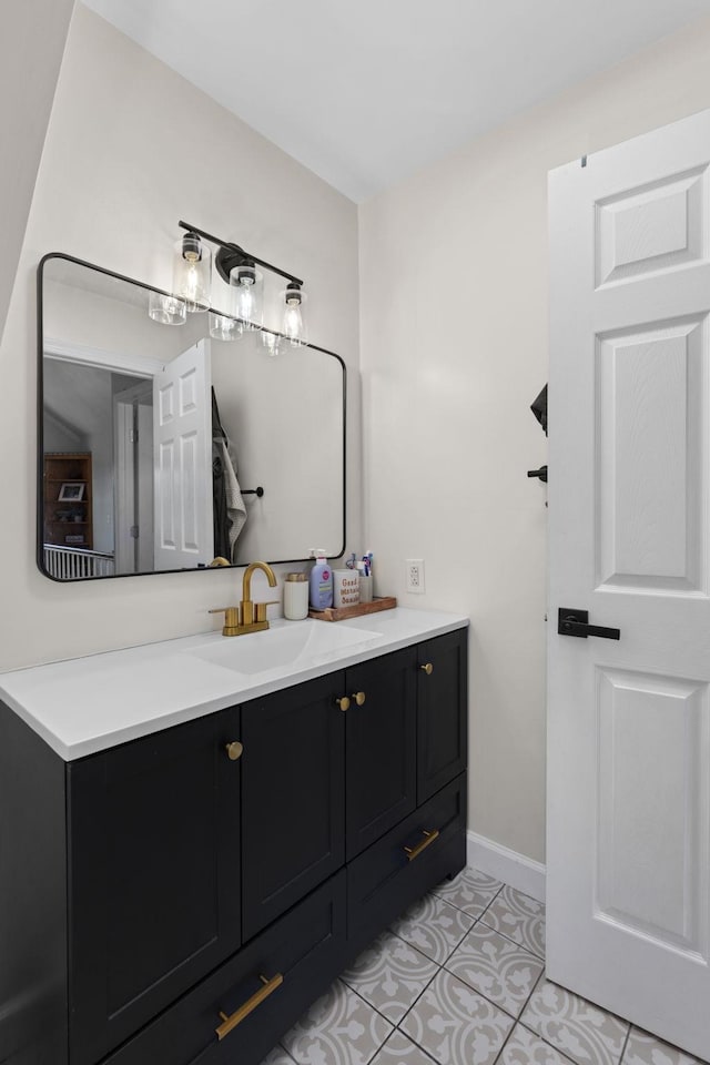 bathroom with tile patterned flooring, vanity, and baseboards