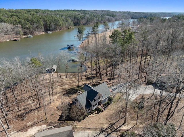 bird's eye view with a water view and a forest view