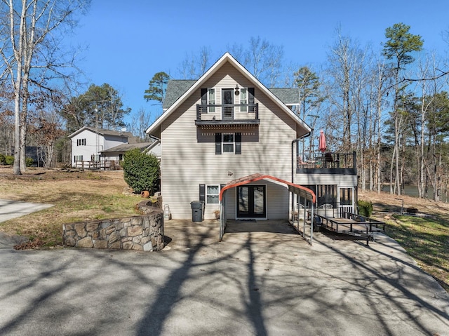 back of house featuring a patio area and a wooden deck