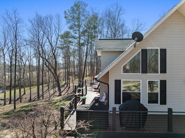 view of side of home featuring a shingled roof