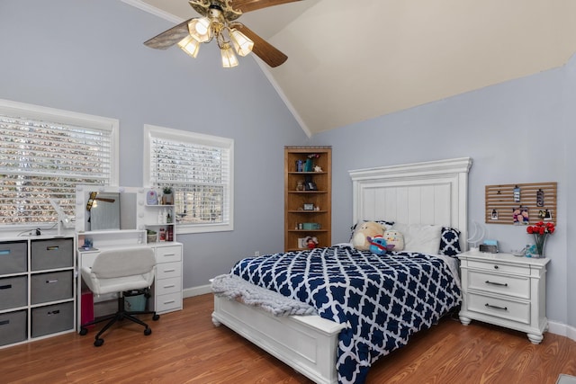 bedroom featuring lofted ceiling, ceiling fan, baseboards, and wood finished floors