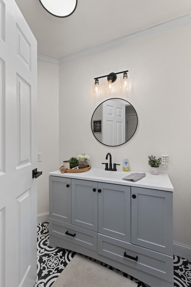 bathroom with ornamental molding, vanity, and baseboards