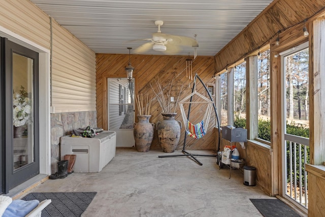 unfurnished sunroom featuring a ceiling fan