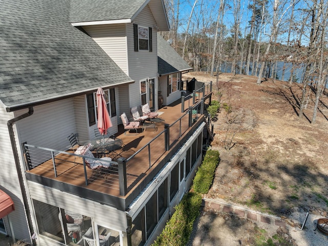 wooden terrace featuring a water view