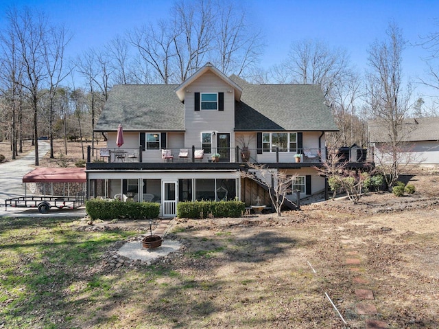 rear view of house with a fire pit, a shingled roof, stairway, and a wooden deck