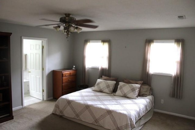bedroom featuring visible vents, baseboards, ceiling fan, and light colored carpet