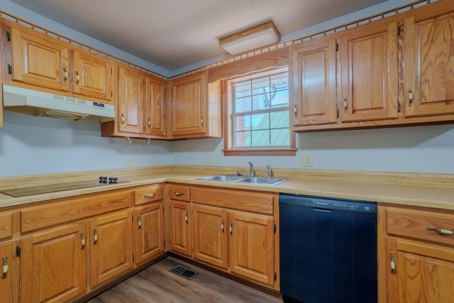 kitchen with dark hardwood / wood-style floors, sink, black dishwasher, and electric stovetop