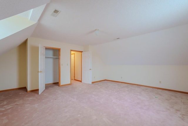 bonus room with carpet floors and lofted ceiling with skylight