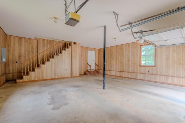 garage featuring electric panel and a garage door opener