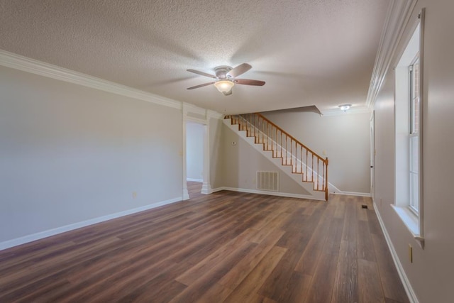 unfurnished room featuring ceiling fan, dark hardwood / wood-style floors, a textured ceiling, and ornamental molding