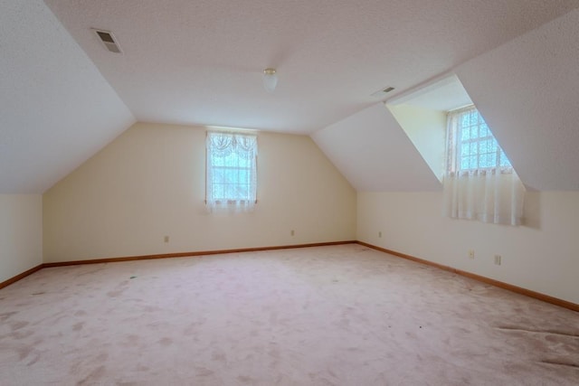 bonus room featuring carpet floors and lofted ceiling