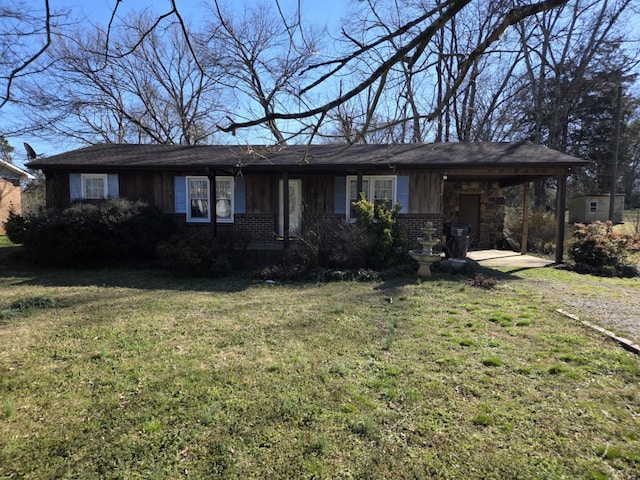 single story home featuring a front lawn, a carport, and brick siding