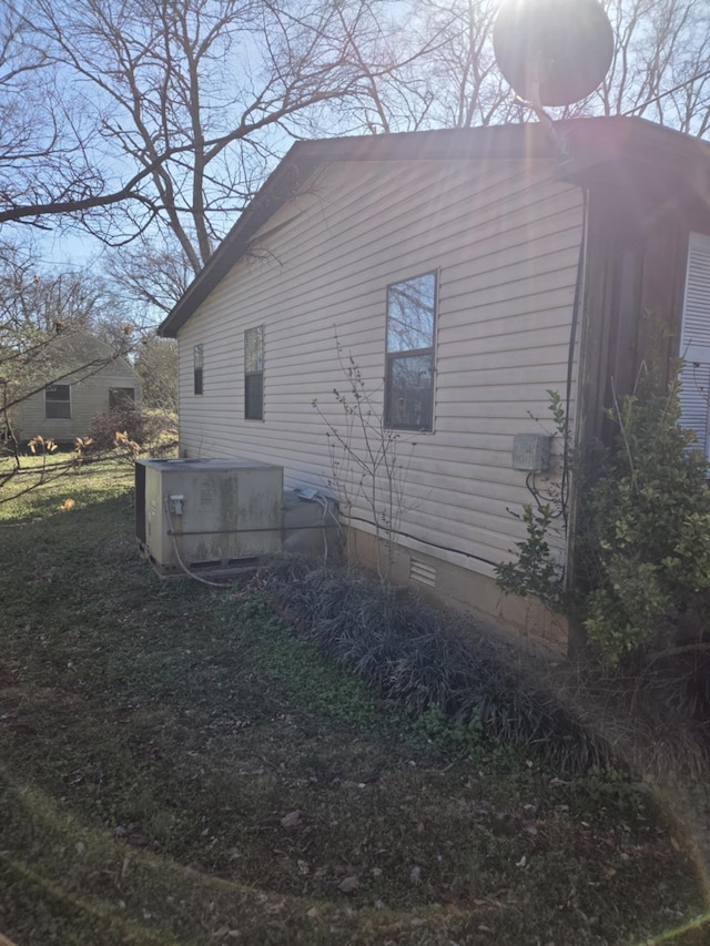 view of side of property with crawl space and central air condition unit