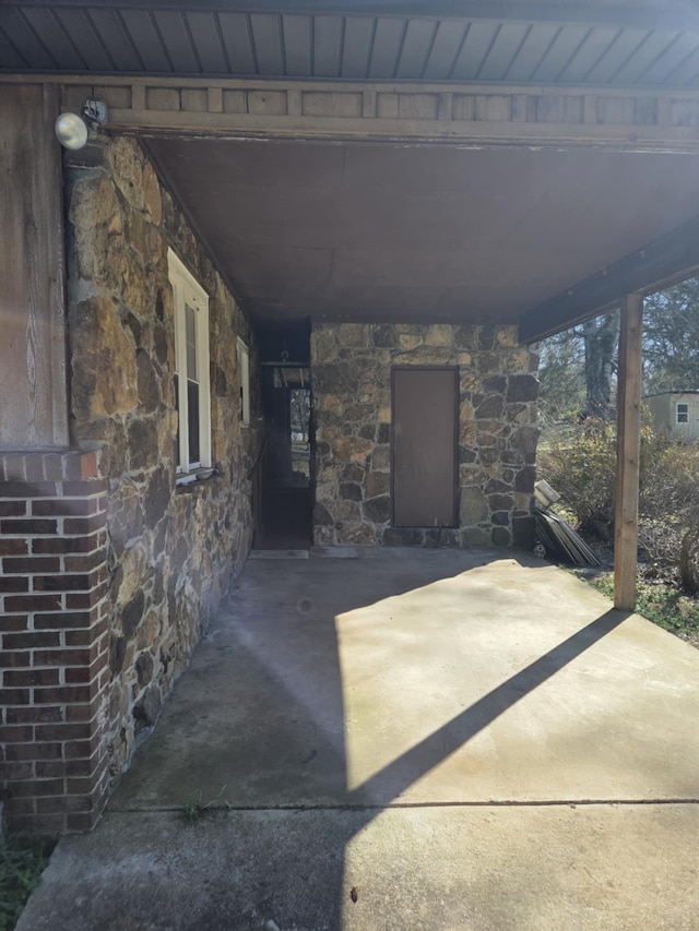 view of patio with a carport and concrete driveway