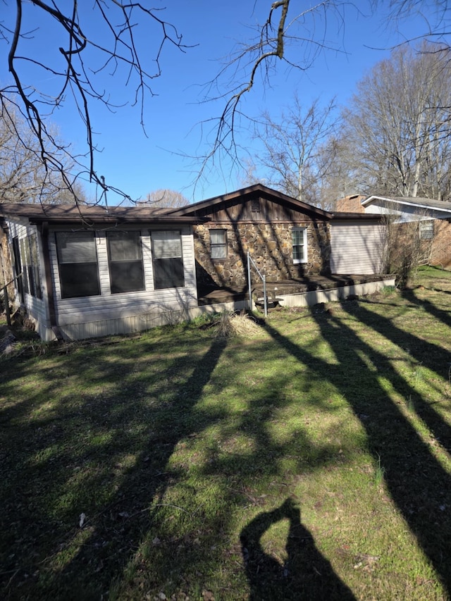 view of side of home with a lawn