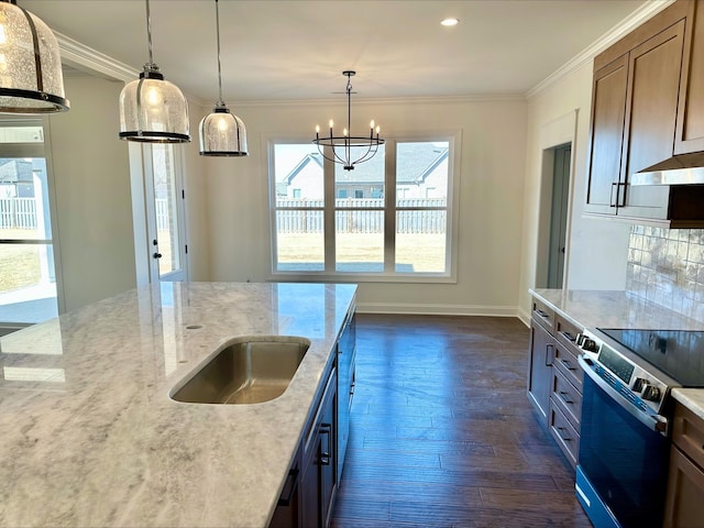 kitchen featuring stainless steel range with electric stovetop, hanging light fixtures, ornamental molding, light stone countertops, and dark wood-type flooring