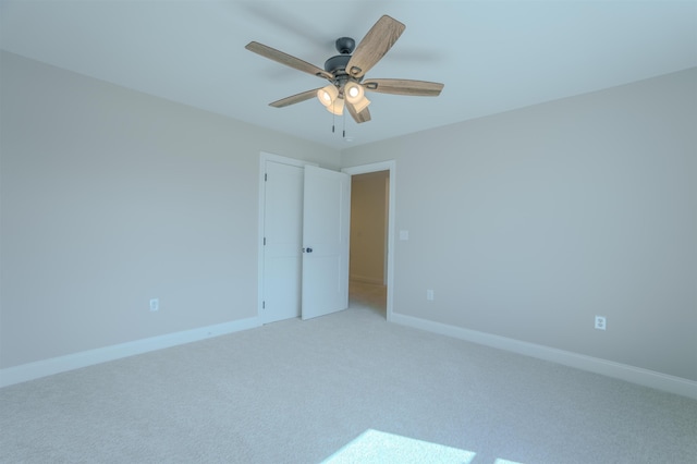 unfurnished bedroom with baseboards, a ceiling fan, and light colored carpet