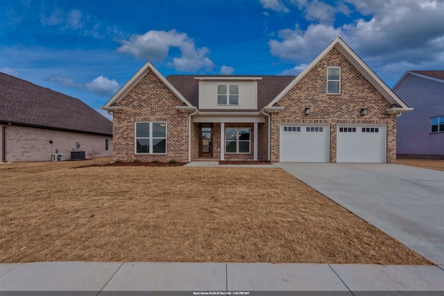 craftsman-style house with brick siding, driveway, a front lawn, and central AC unit