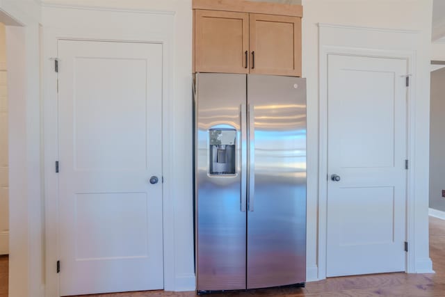 kitchen with wood finished floors, light brown cabinets, and stainless steel fridge with ice dispenser