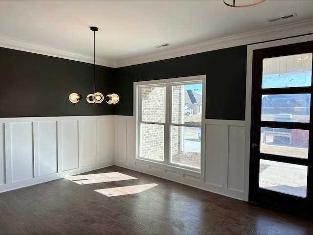 unfurnished dining area featuring crown molding and dark hardwood / wood-style flooring