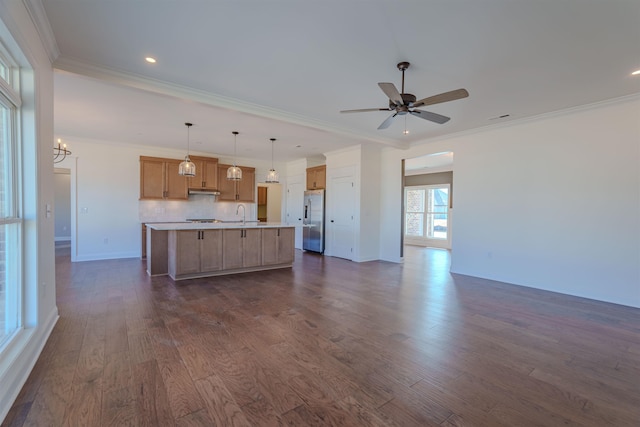 kitchen with a center island with sink, dark wood-style floors, open floor plan, light countertops, and stainless steel refrigerator with ice dispenser