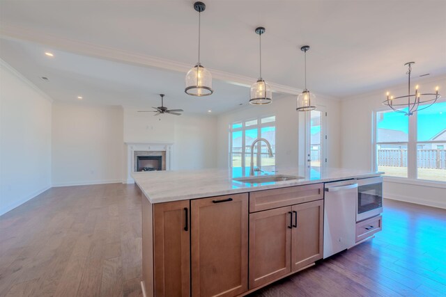 unfurnished living room with dark wood-type flooring, ceiling fan, and ornamental molding