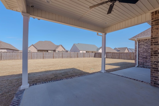 view of patio / terrace featuring ceiling fan, a fenced backyard, and a residential view