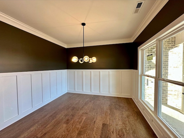 unfurnished dining area featuring ornamental molding, dark hardwood / wood-style flooring, and a notable chandelier