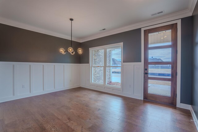 empty room featuring crown molding and dark hardwood / wood-style floors