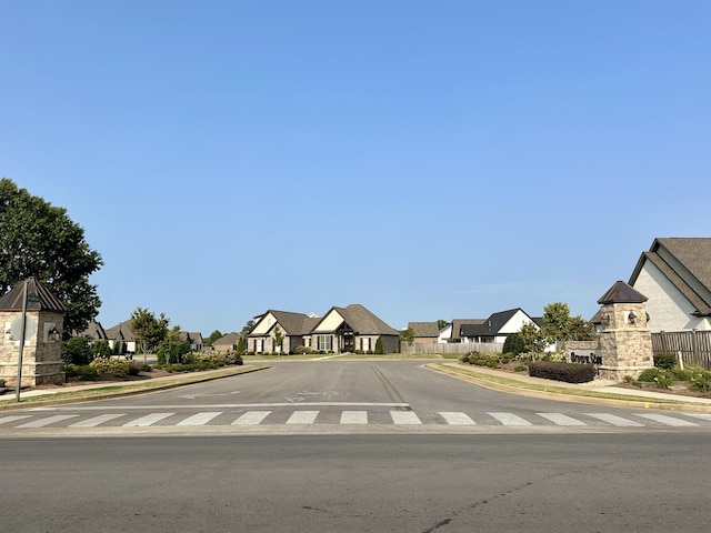 view of road with a residential view, curbs, and sidewalks