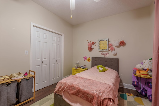  - bedroom with wood finished floors, a closet, and a ceiling fan