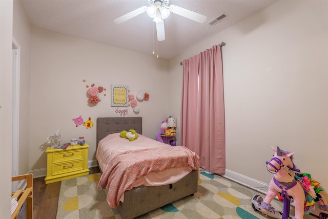  - bedroom featuring ceiling fan and wood finished floors
