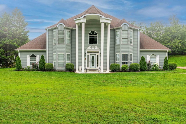  - view of front of home featuring a front lawn and a shingled roof
