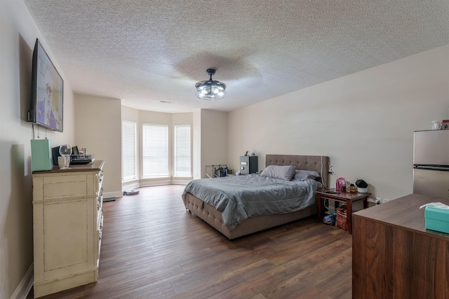  - bedroom with dark wood finished floors, a textured ceiling, and ceiling fan
