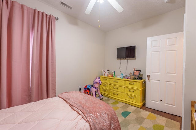  - bedroom with light wood-type flooring and a ceiling fan