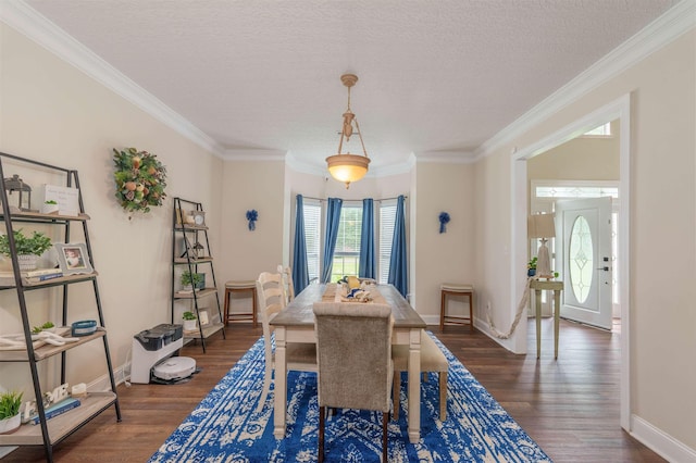  - dining area with crown molding, wood finished floors, and a textured ceiling